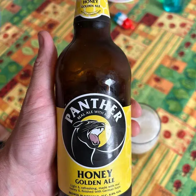 Panther Brewery Honey bottle in customers hand