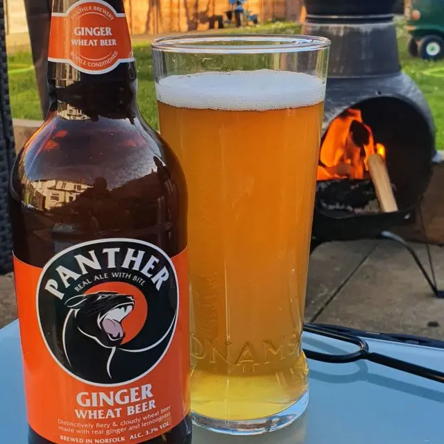 Bottle of Panther Brewery Ginger pour in a glass next to the bottle